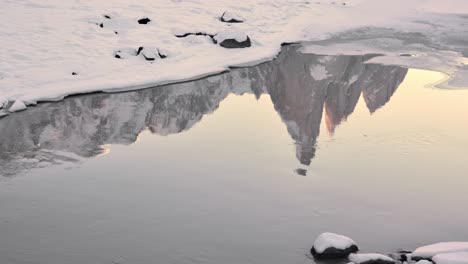 Cerro-Torre-reflection-in-a-snowy-river-during-winter-in-Los-Glaciares-National-Park,-Argentina