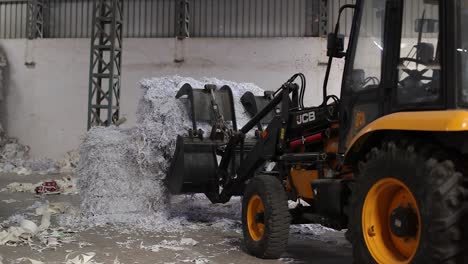 JCB-is-picked-up-and-put-inside-the-recycling-machine
