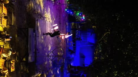 VERTICAL,-Thai-Performers-Entertaining-People-With-a-Fire-Show-at-Beach-Bar