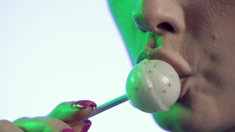 Close-Up-Of-Woman's-Mouth-and-Lips-Licking-Lollipop-Candy-With-Tongue,-Studio-Shot