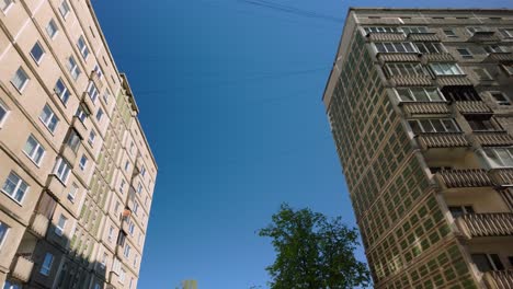Low-angle-forward-movement-footage-of-Soviet-era-apartment-blocks-in-Plavieki,-Riga,-Latvia
