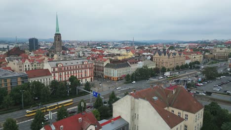 Aerial-view-of-a-Pilsen-cityscape-with-historic-architecture,-roads,-and-vehicles