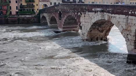 Verona-river-Adige-and-bridge-Ponte-Pietra,-with-panorama-of-the-old-city-and-gates