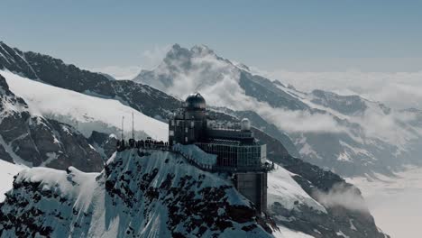 Flyover-of-Jungfraujoch-Station-with-Snowy-Alps
