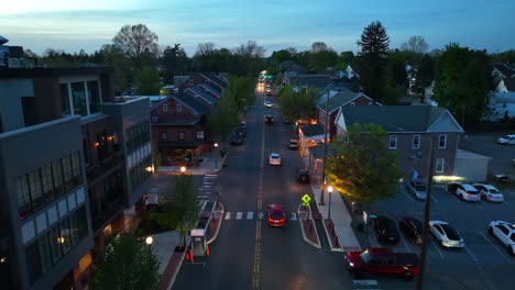 Driving-cars-on-main-street-of-historic-american-town-at-dusk