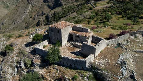 Legendary-Leader's-Tower-in-Albania's-Coastal-Mediterranean-Village:-Stone-clad-Panoramic-Hillside-Overlooking-Beautiful-Olive-Grove