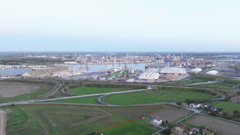 Industrial-and-port-area-of-Ravenna-,chemical-and-petrochemical-pole,thermoelectric,metallurgical-plants-and-hydrocarbon-refinery-and-liquefied-natural-gas-tanks,shot-at-sunrise