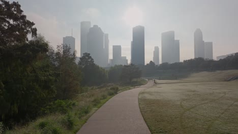 Park-trail-in-Buffalo-Bayou-Park-on-a-foggy-morning-with-Houston-skyline-in-the-background