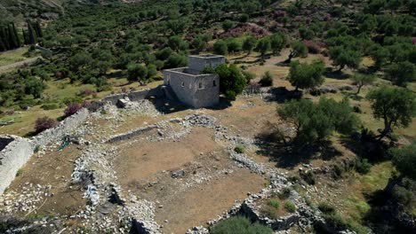 Ancient-Stone-Towers-in-Ruins-on-a-Remote-Mountain-in-Albania,-Featuring-the-Historic-Old-Houses-of-Qeparo-Village