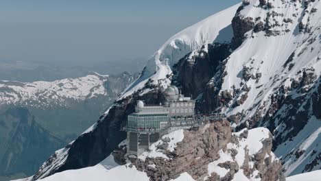 Circling-Left-Shot-of-Jungfraujoch-Station-from-Sunny-to-Shady-Side