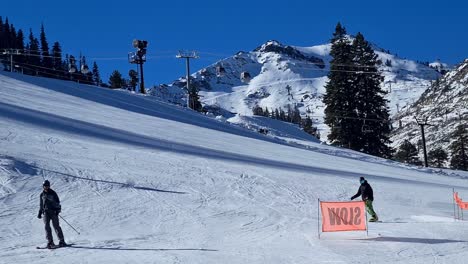 Skiers-and-Snowboarders-on-Ski-Track-in-Olympic-Valley,-Lake-Tahoe,-California-USA-on-Sunny-Winter-Day