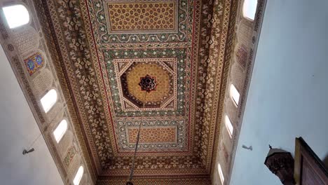 Decorated-roof-with-wood-carving-and-Islamic-art,-riad-in-Morocco