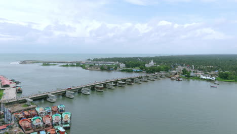 Neendakara-bridge-and-Fishing-Harbour-kollam-kerala,-during-trawling-ban-drone-view-from-island