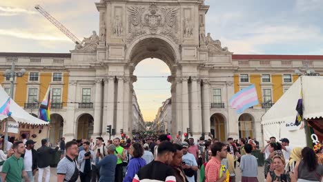 Tourists-walk,-taking-photos-in-Arraial-Lisboa-Pride-at-Praça-do-Comércio-Square,-Lisbon,-Portugal