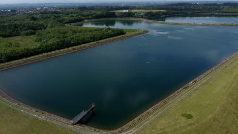 Water-supply-storage-reservoir-aerial-view-rising-over-rural-countryside-lake-supply