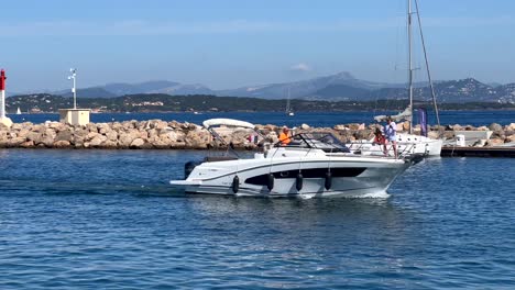 Couple-on-private-small-yacht-leaving-port-of-French-Town-at-golden-sunset