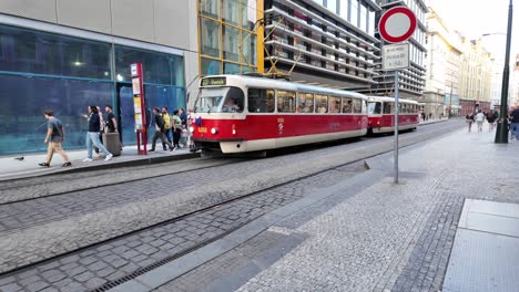 People-get-off-and-board-the-red-tram-in-Prague