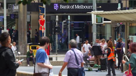 Pedestrians-strolling-in-the-bustling-Bourke-Street-Mall,-a-shopping-and-commercial-precinct-in-downtown-Melbourne-city,-featuring-Bank-of-Melbourne-on-the-corner-of-Bourke-and-Elizabeth-Streets