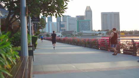 People-Jog,-Brisk-Walk-Outdoors,-At-The-Marina-Bay,-Singapore-In-Morning-Day