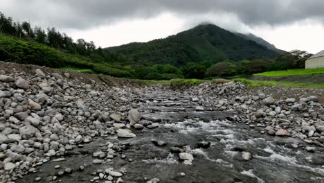 Low-Aerial-Drone-Racing-Up-A-River-Stream