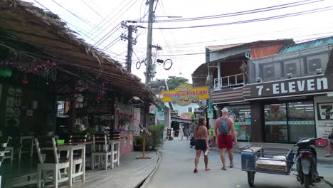7-Eleven-tuk-tuks-driving-down-a-narrow-walkingstreet-lined-with-shops-and-homes-koh-Lipe-asia