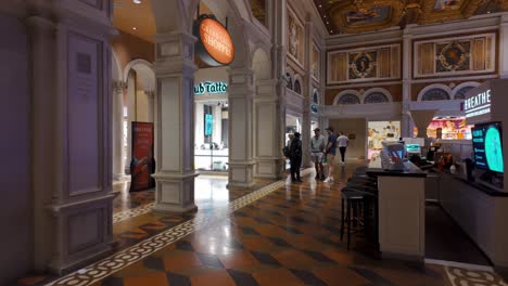 Stock-footage-of-people-socializing-inside-the-Forum-Shops-at-Caesars-Palace,-Las-Vegas,-featuring-ornate-decor,-vibrant-shops,-and-elegant-architecture