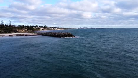 Aerial-over-Indian-Ocean-to-closeup-Cottesloe-Groin,-Perth,-Western-Australia