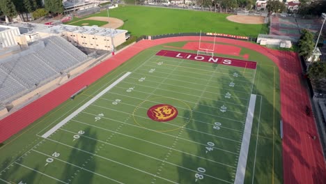 Fairfax-high-school-Lions-football-field-in-Los-Angeles,-California---aerial-flyover