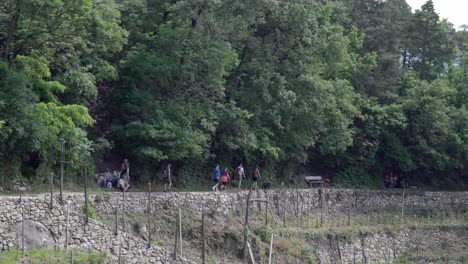 Hikers-walk-along-part-of-the-irrigation-channel-hiking-path-above-Algund---Lagundo,-South-Tyrol,-Italy