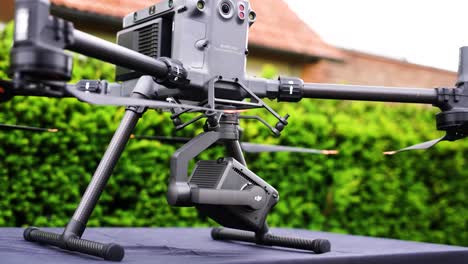 Heavy-industrial-drone-with-moving-camera-payload-on-outdoor-surface,-Czechia