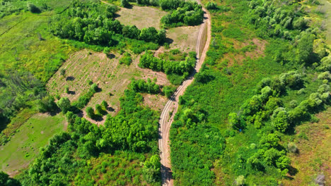 Aerial-view-tilting-over-a-dirt-road-in-Skadar-lake-national-park,-in-Montenegro