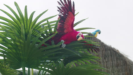 Beautiful-shot-of-toy-parrots-placed-in-a-tree-during-a-medieval-fair-in-southern-Spain,-shot-in-4k-slow-motion