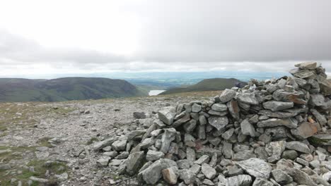 Slow-panning-shot-of-the-Ben-Chonzie-summit-overlooking-the-valley-with-a-loch