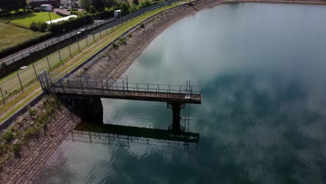 Water-supply-reservoir-platform-aerial-view-looking-down-over-rural-idyllic-countryside-lake-supply