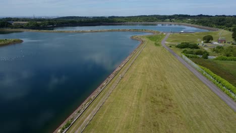 Water-supply-reservoir-sewage-contamination-social-issues-aerial-view-descending-alongside-lake