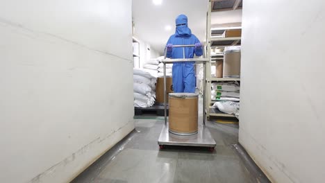 Men-carrying-large-bowls-full-of-chemicals-into-the-machine