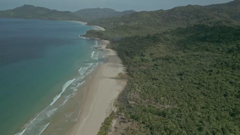 Forest,-sand-beach-and-turquoise-sea-in-sunny-Philippines,-wide-aerial