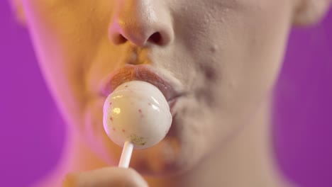 Cute-caucasian-woman-sucks-on-white-lollipop,-concept-oral-sex,-close-up-face