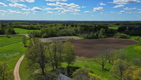 Aerial-drone-shot-of-a-peaceful-countryside-farmland-with-green-grass