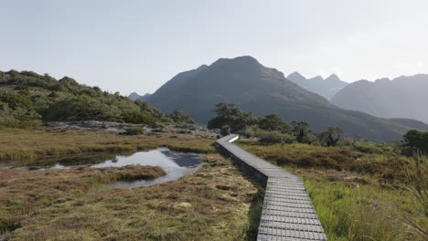 Wooden-path-in-Key-Summit,-Routeburn-Track-on-a-sunny-day-in-Fiordland,-New-Zealand