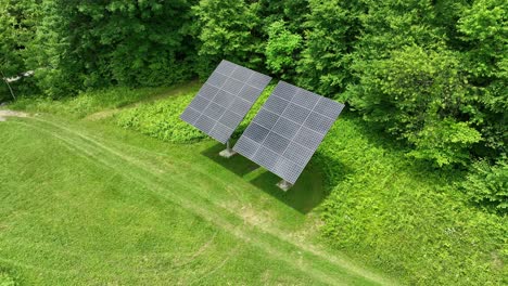 Solar-Panels-installed-on-grass-field-in-front-of-forest-during-sunny-day