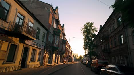 An-early-morning-drive-through-an-empty-street-in-Daugavpils,-illuminated-by-the-orange-light-of-sunrise