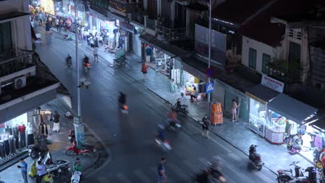 Nighttime-timelapse-of-Dong-Kinh-Nghia-Thuc-Square-in-Vietnam,-capturing-bustling-street-activity-and-vibrant-market-life