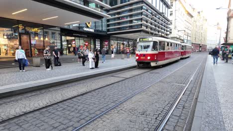 A-tram-with-people-arrives-at-the-stop-in-Prague