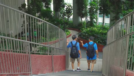 Two-Senior-Men-Tourist-Wear-Backpack-Walking-Downstairs-At-The-City-Garden