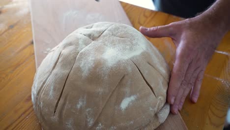 Baker-scoring-dough-before-baking-bread