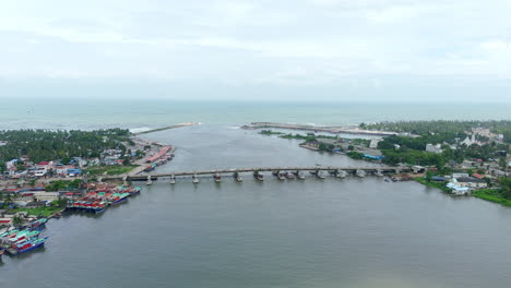 Neendakara-bridge-and-Fishing-Harbour-kollam-kerala,-during-trawling-ban-drone-view-from-island