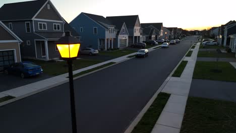 Aerial-view-of-quiet-neighborhood-with-single-family-homes-and-parking-cars-at-dawn