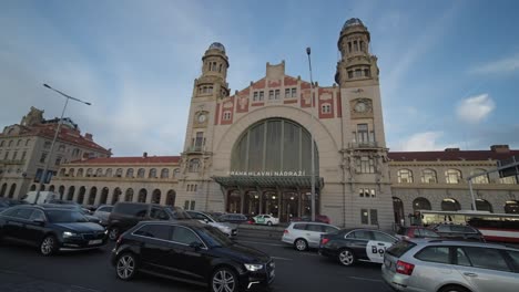 Wide-pan-shot-of-Prague's-Praha-hlavní-nádraží-historic-railway-station-with-car-traffic-jam,-busy-traffic,-Czechia,-Czech-Republic