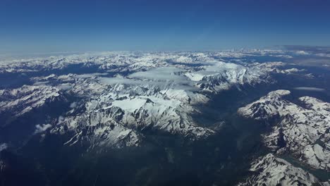 POV-aerial-view-of-snowed-Alps-range-shot-from-an-airplane-flying-northbound-with-the-Mont-Blanc-in-front